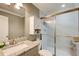 Bathroom with granite vanity, frosted glass shower doors, and white medicine cabinet at 1952 Sugarstone Dr, Lawrenceville, GA 30043