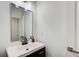 Modern bathroom features a sleek vanity with dark wood cabinets and a silver-framed mirror at 1952 Sugarstone Dr, Lawrenceville, GA 30043