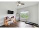 Bright bedroom with hardwood floors, ceiling fan, and large windows, ideal for a home gym at 1952 Sugarstone Dr, Lawrenceville, GA 30043