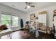 Bright bedroom with hardwood floors, ceiling fan, and large windows is perfect for an office at 1952 Sugarstone Dr, Lawrenceville, GA 30043
