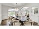 Elegant dining room featuring a large dark wood table and a chandelier for gatherings at 1952 Sugarstone Dr, Lawrenceville, GA 30043