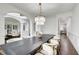 Spacious dining area with chandelier, large dining table and a view of other living areas at 1952 Sugarstone Dr, Lawrenceville, GA 30043