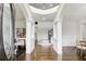 Bright open foyer with a staircase and dark wood floors for a grand entrance at 1952 Sugarstone Dr, Lawrenceville, GA 30043