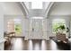 Bright foyer with soaring ceilings, hardwood floors, and an ornate glass front door at 1952 Sugarstone Dr, Lawrenceville, GA 30043