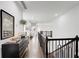 Bright hallway with hardwood floors, elegant staircase, and stylish decor on the sideboard at 1952 Sugarstone Dr, Lawrenceville, GA 30043