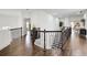 Spacious hallway with dark hardwood floors, decorative railing, and views to other rooms at 1952 Sugarstone Dr, Lawrenceville, GA 30043