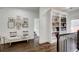 Bright hallway features a bookcase, comfortable seating and art, perfect for a reading nook at 1952 Sugarstone Dr, Lawrenceville, GA 30043