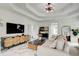 Living room with marble floors, modern furniture, and a tray ceiling with decorative lighting at 1952 Sugarstone Dr, Lawrenceville, GA 30043
