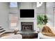 Bright living room features a stone fireplace, white trim, and large windows at 1952 Sugarstone Dr, Lawrenceville, GA 30043