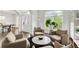 Inviting living room with neutral furniture, coffee table, and a view of the foyer at 1952 Sugarstone Dr, Lawrenceville, GA 30043