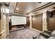 Home theater with projector screen, comfortable seating, and surround sound speakers at 1952 Sugarstone Dr, Lawrenceville, GA 30043