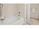 Bathroom featuring a soaking tub with tile floors and glass enclosed shower at 220 Ashley Se Ln # 19, Smyrna, GA 30080