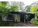 Shot of a derelict home's overgrown yard and exterior in visible disrepair at 2440 Andy Mountain Rd, Villa Rica, GA 30180