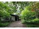 Exterior shot of neglected home with overgrown vegetation and run-down appearance at 2440 Andy Mountain Rd, Villa Rica, GA 30180