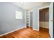 Bedroom with hardwood floors, window, and closet featuring shelving, and an open doorway at , Forest Park, GA 30297