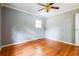This bedroom features hardwood floors, neutral paint, base and crown molding, and a ceiling fan at , Forest Park, GA 30297