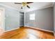 Bright bedroom with hardwood floors, a closet, and a large window at , Forest Park, GA 30297