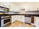 Cozy kitchen featuring stainless steel appliances, white cabinets, and modern tile flooring at , Forest Park, GA 30297