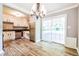 Well-lit kitchen with wood tile flooring, stainless steel appliances, and white cabinets at , Forest Park, GA 30297