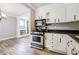 Stylish kitchen with modern appliances, white cabinets, and an open layout at , Forest Park, GA 30297