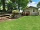 View of backyard with green lawn and back entrance featuring wood stairs at 1625 Orlando Sw St, Atlanta, GA 30311