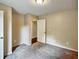 A bright, carpeted bedroom with a closet and neutral-toned walls at 1625 Orlando Sw St, Atlanta, GA 30311