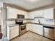 Modern kitchen featuring white cabinets, subway tile backsplash and stainless appliances at 1625 Orlando Sw St, Atlanta, GA 30311