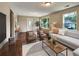 Well-lit living room featuring contemporary furniture, hardwood floors, and views of the surrounding landscape at 1625 Orlando Sw St, Atlanta, GA 30311