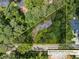 Aerial view of a property surrounded by lush trees and bordered by a yellow parcel line at 265 Mayfield Rd, Alpharetta, GA 30009