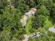 Aerial shot featuring a cozy home surrounded by verdant trees and a nearby road at 265 Mayfield Rd, Alpharetta, GA 30009