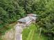 Aerial perspective of a charming home with a covered porch nestled among trees at 265 Mayfield Rd, Alpharetta, GA 30009