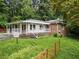 Front exterior features a quaint porch, white columns, and brick accents at 265 Mayfield Rd, Alpharetta, GA 30009