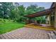 Backyard featuring a covered deck with dining area and a brick patio for outdoor gatherings at 407 Doris Dr, Woodstock, GA 30188