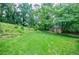 Expansive backyard with green grass and a storage shed, ideal for outdoor activities and relaxation at 407 Doris Dr, Woodstock, GA 30188