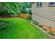 Well-maintained backyard with lush green lawn and landscaped garden bed at 407 Doris Dr, Woodstock, GA 30188