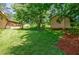 Lush backyard featuring mature trees, shed, and open green space at 407 Doris Dr, Woodstock, GA 30188