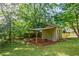 Backyard view with a storage shed, open space under the shelter, and a fenced perimeter at 407 Doris Dr, Woodstock, GA 30188