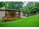 Backyard with a wooden deck, patio area, and grill, perfect for outdoor dining at 407 Doris Dr, Woodstock, GA 30188