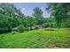 Green backyard providing ample space and greenery, creating a peaceful outdoor oasis at 407 Doris Dr, Woodstock, GA 30188