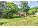 Spacious backyard with shed, garden, and covered porch, perfect for relaxing outdoors at 407 Doris Dr, Woodstock, GA 30188