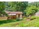 Charming home featuring a wooden deck, garden, and a peaceful, wooded backyard setting at 407 Doris Dr, Woodstock, GA 30188