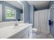 Bathroom with large vanity and mirror, plus natural lighting from the window at 407 Doris Dr, Woodstock, GA 30188