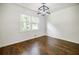 Bright dining area featuring hardwood floors, a modern light fixture, and a large window at 407 Doris Dr, Woodstock, GA 30188