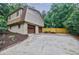 Spacious driveway leads to a two-car garage on this home with nice landscaping at 407 Doris Dr, Woodstock, GA 30188