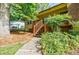 Exterior view of the home featuring a charming wooden staircase leading to the entrance at 407 Doris Dr, Woodstock, GA 30188