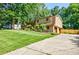 Charming two-story home with a brick facade, attached garage, and a well-manicured lawn and driveway at 407 Doris Dr, Woodstock, GA 30188