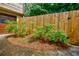 Landscaped side yard with lush greenery and a wooden fence at 407 Doris Dr, Woodstock, GA 30188