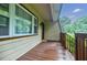 Covered front porch with wood decking offers a relaxing outdoor space at 407 Doris Dr, Woodstock, GA 30188