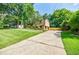 Expansive front yard with lush green lawn, leading to the charming home with a driveway and garage at 407 Doris Dr, Woodstock, GA 30188
