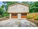 Spacious two-car garage with brick facade, offering ample parking and storage space at 407 Doris Dr, Woodstock, GA 30188